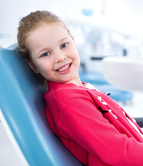 Smiling young girl in dental office for children's dentistry appointment
