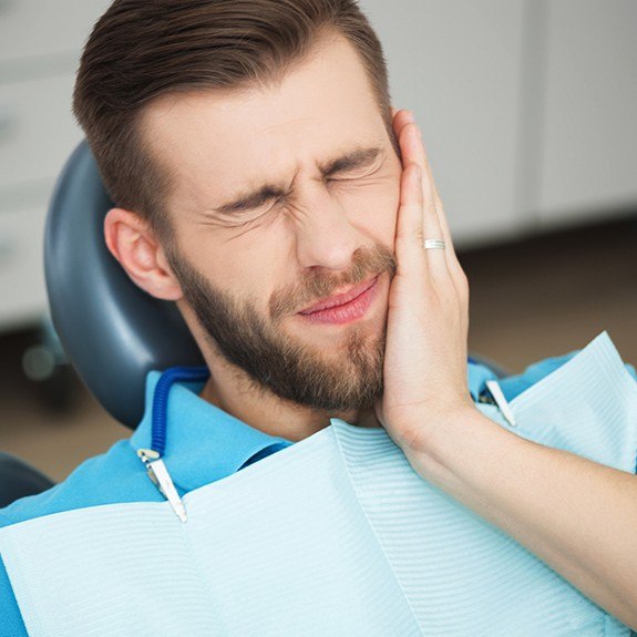 Man in pain at dental office for emergency dentistry