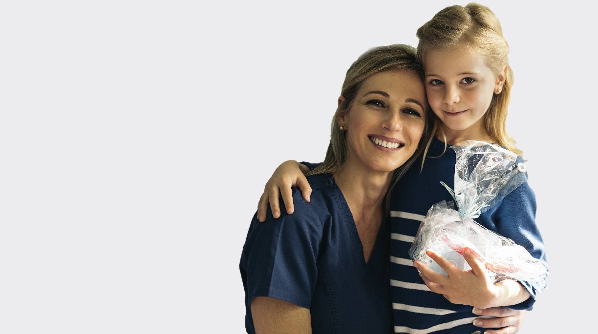 Mother and daughter with oral hygiene gift basket