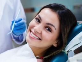 Smiling woman receiving dental checkup