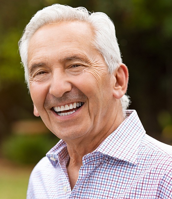 Older man sharing healthy smile after periodontal therapy