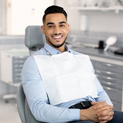 Patient smiling while sitting in treatment chair