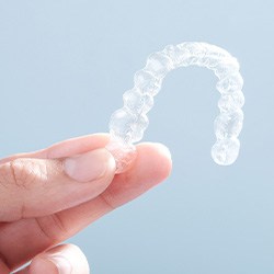 Patient holding clear aligner