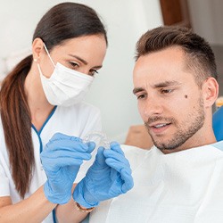 Dentist shows patient nightguard