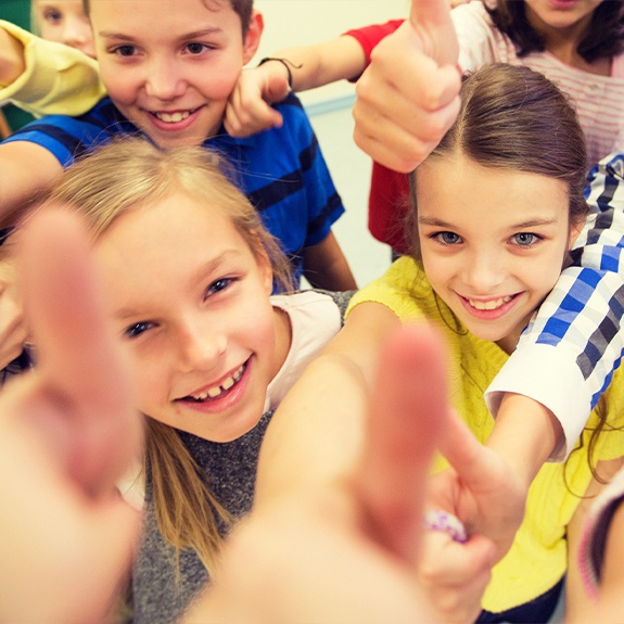 Group of kids giving thumbs up