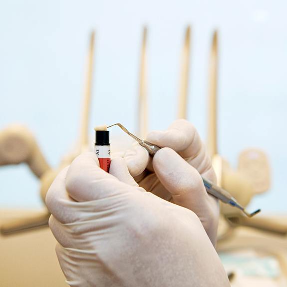 A dentist preparing to apply composite resin