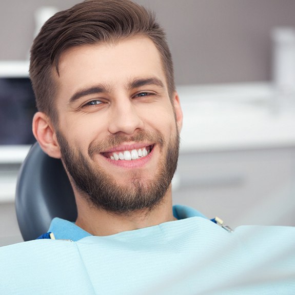 A smiling young man in a dentist’s chair