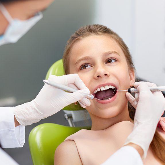 Young girl receiving dental checkup