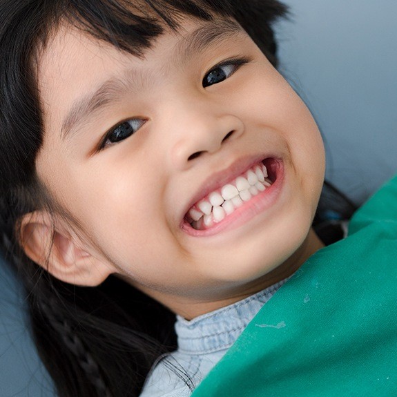 Smiling child after tooth-colored filling placement