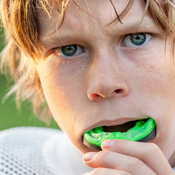 Teen boy placing green sportsguard