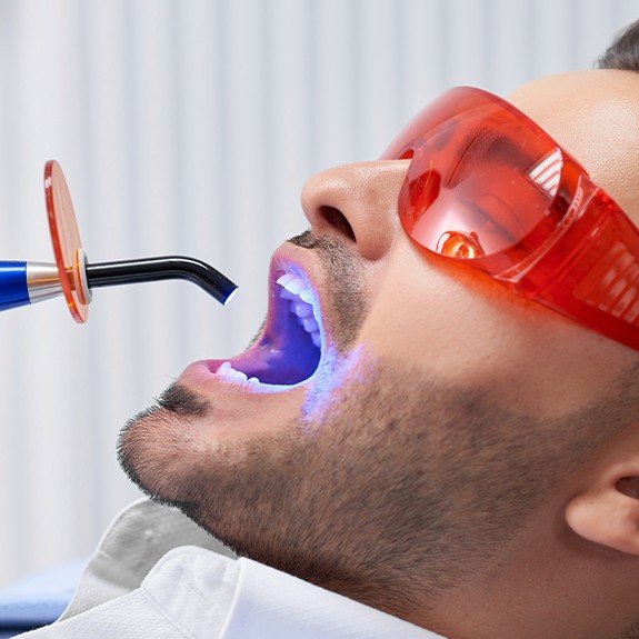 Man receiving cosmetic dental bonding treatment