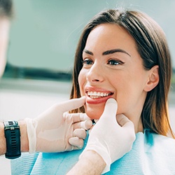 dentist looking at patient’s teeth