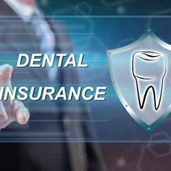 Dentist in Lancaster pointing to dental insurance graphic