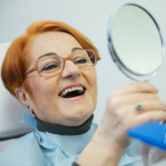 Woman smiling with dentures in Lancaster