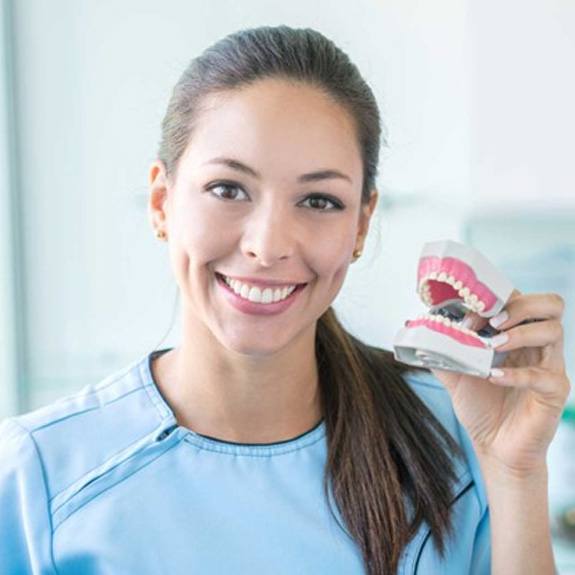 a closeup of someone holding dentures