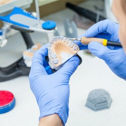 a lab technician crafting dentures in Lancaster