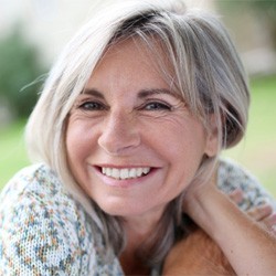 a patient smiling after receiving dentures in Lancaster