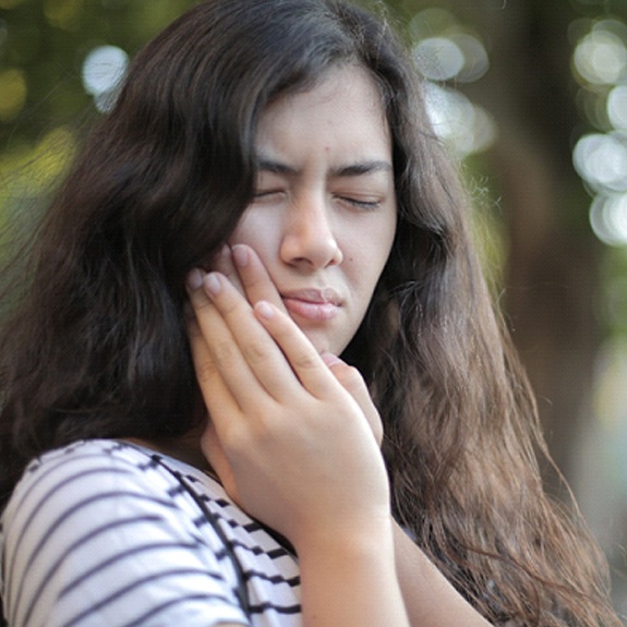 Woman in pain from a dental emergency