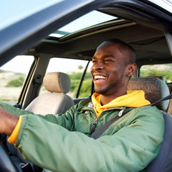 Man smiles while driving