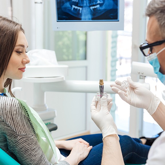 a dentist explaining how dental implants work