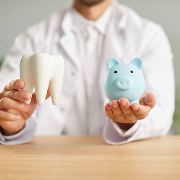 a dentist holding a piggy bank