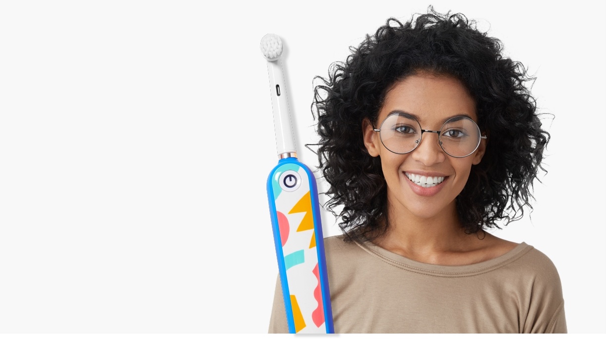 Woman with healthy smile and electric toothbrush