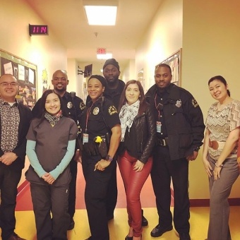 Team members and police officers at community health event