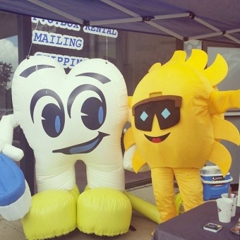 Tooth and Sun mascots at community event