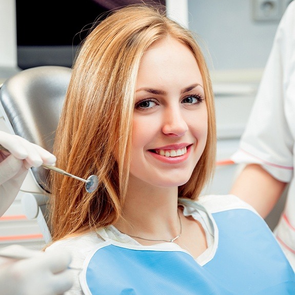 Woman receiving preventive dentistry covered by dental insurance