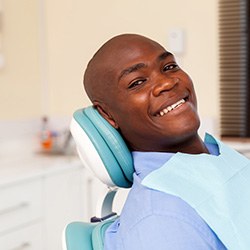 Smiling patient sitting in treatment chair