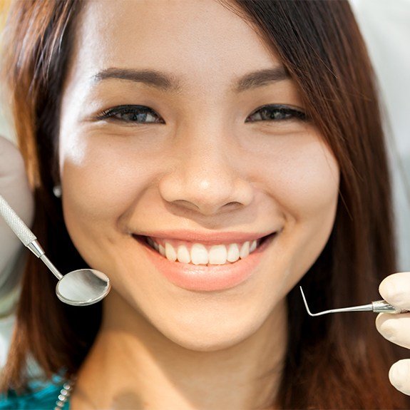 Woman smiling during preventive dentistry appointment