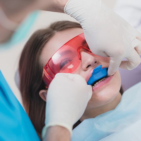 Young woman receiving fluoride treatment