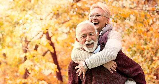 Laughing older man and woman outdoors