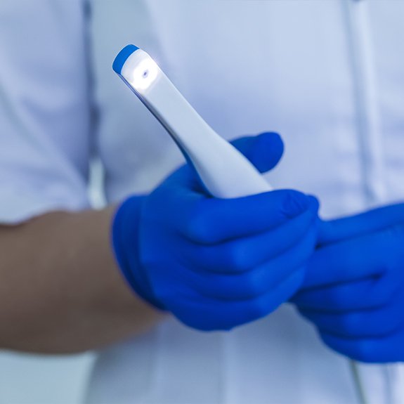 Dentist holding intraoral camera hand tool