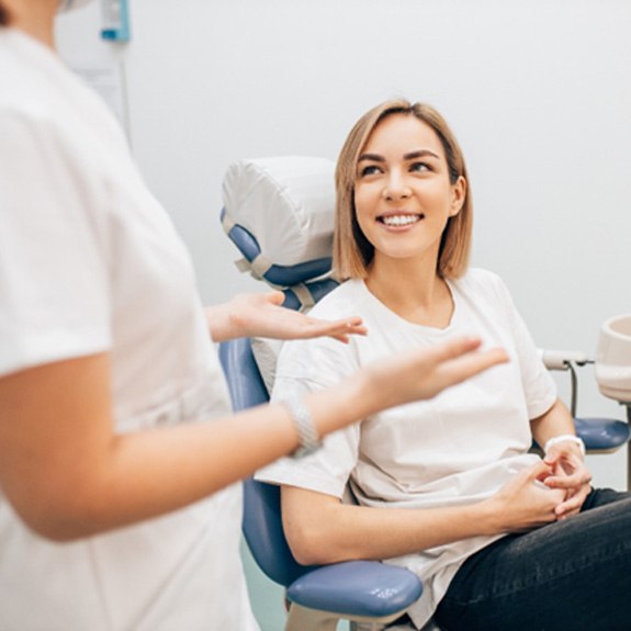 Dentist explaining the cost of veneers in Lancaster