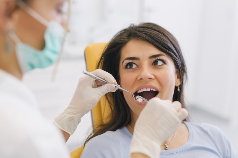 A woman getting a checkup from a dentist in Lancaster.