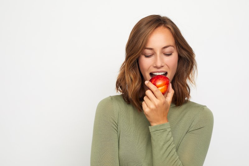 young woman eating apple