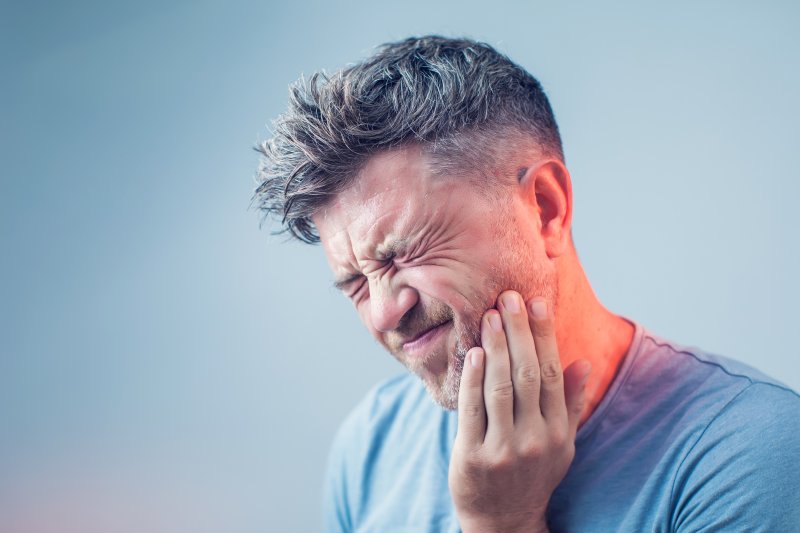 man dealing with tooth pain in Lancaster